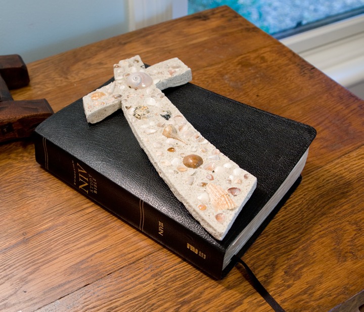 Curved cross on Bible